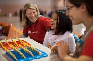 Carolyn, 8-year-old Kelly and Save the Children staff member Petra Aldrich share a laugh inside an Atlantic City shelter.