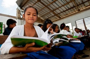 Fifth-graders from Panay Island in the Philippines studying math in a classroom damaged by Typhoon Haiyan. Photo credit: Susan Warner for Save the Children.